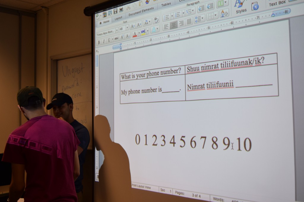 Key phrases are projected onto the screen for students to activate during the activity