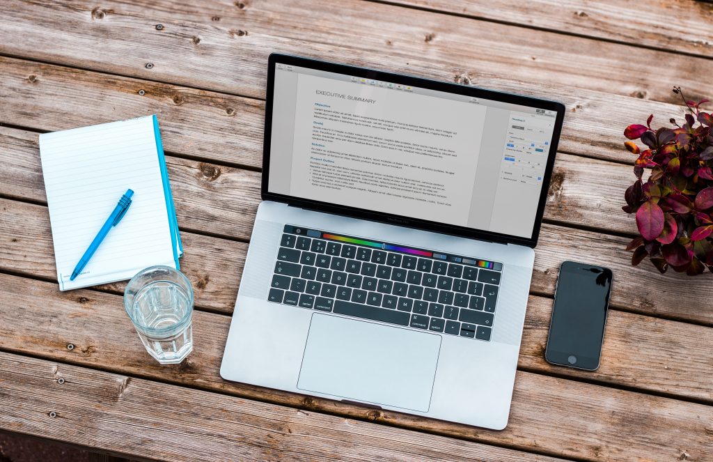 Laptop on table with text on screen